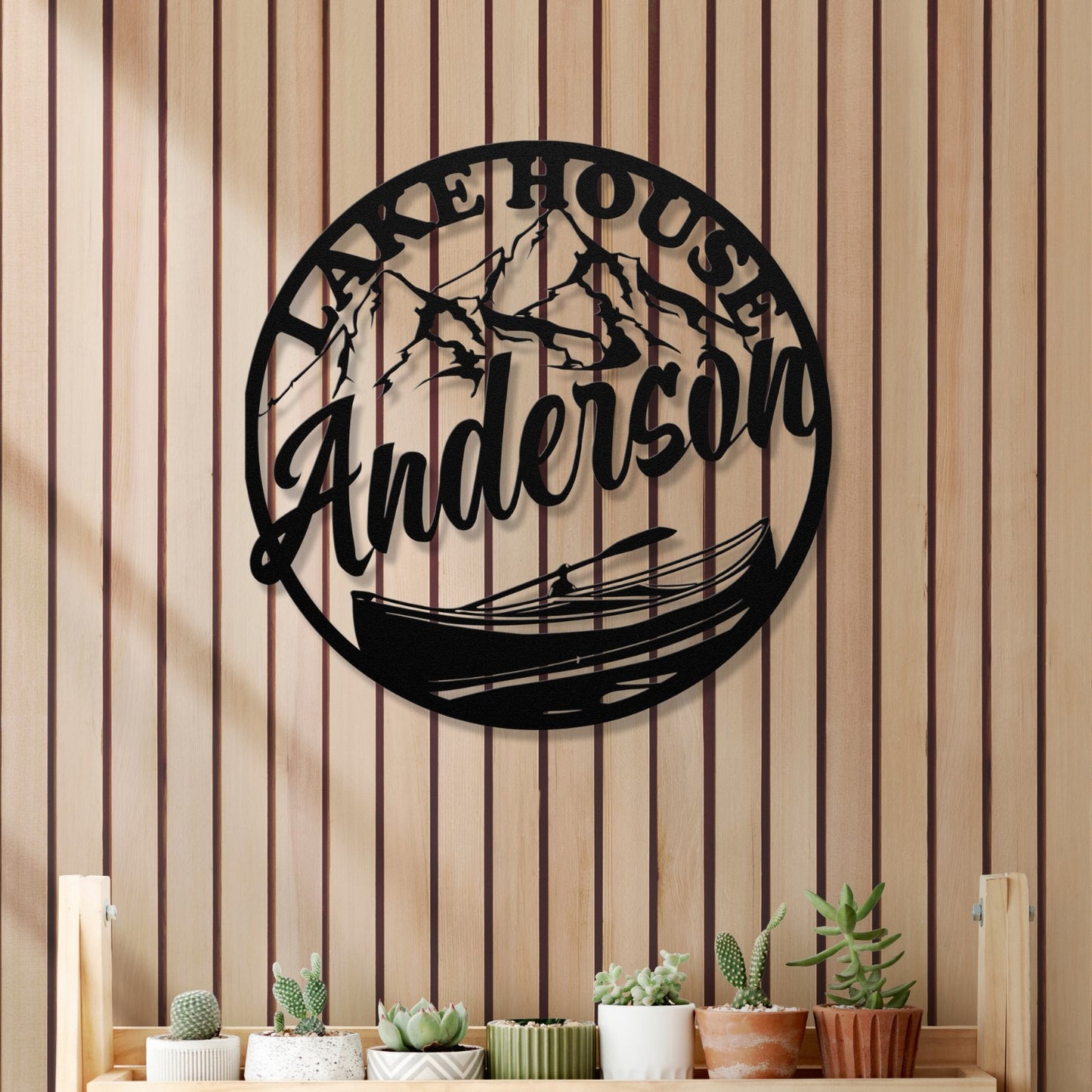 Decorative wall art with 'Lake House Anderson' text on a striped wall.