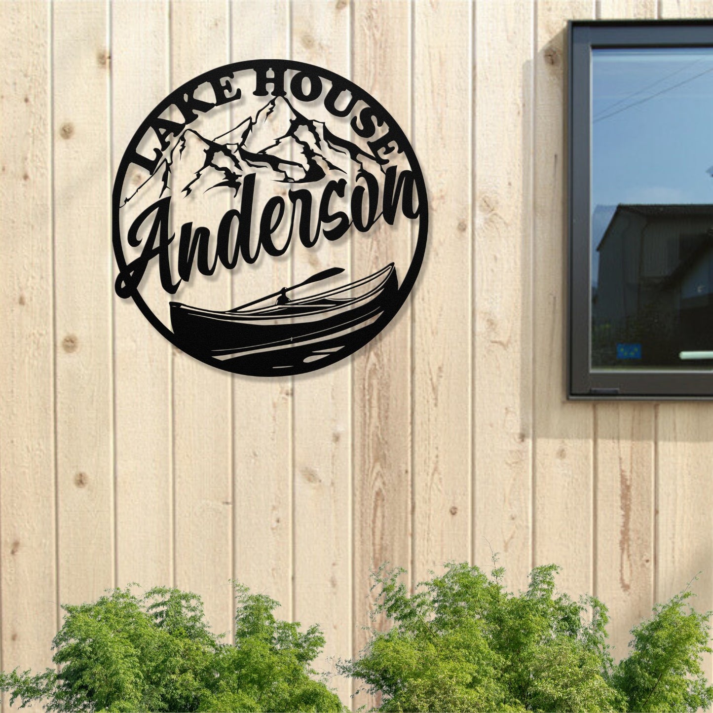 Decorative metal sign with 'Lake House Anderson' on a wooden wall.