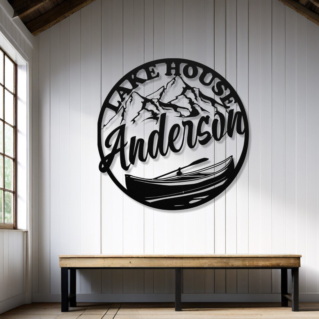 Decorative wall art with 'Lake House Anderson' text in a room with wooden floor and window.