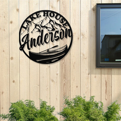 Decorative metal sign with 'Lake House Anderson' on a wooden wall.