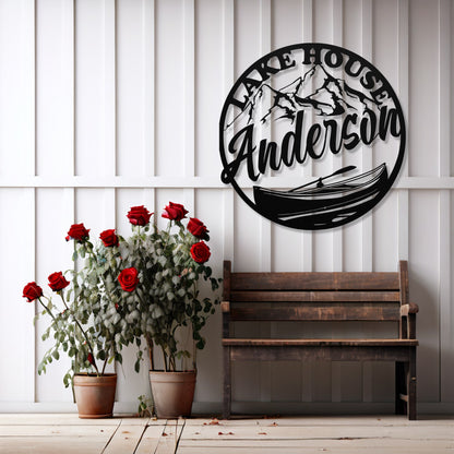 Decorative wall art with 'Lake House Anderson' design, wooden bench, and potted plants on a white paneled wall.